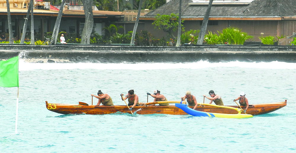 The Keaukaha women's masters 40 crew is first to the finish line Saturday at the Kamehameha Day Regatta at Kailua Bay.