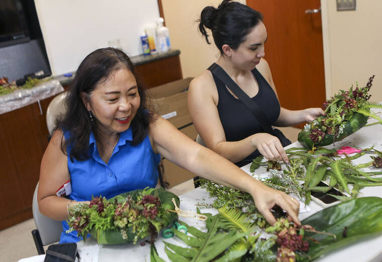 Workshop participants learn how to craft wreaths with native flora
